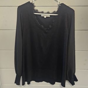 Cute dressy black top. Sheer sleeves.